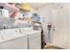 Functional laundry room with a washer, dryer, and ample shelving for storage at 4726 Southern Trail, Myrtle Beach, SC 29579