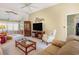 Bright living room featuring a ceiling fan, entertainment center and large sofa at 4726 Southern Trail, Myrtle Beach, SC 29579