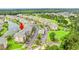 An aerial view of condo buildings with assigned parking spots next to a pond and fountain, surrounded by green spaces at 4865 Luster Leaf Circle # 402, Myrtle Beach, SC 29577
