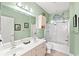 Well-lit bathroom with a double sink vanity, a shower-tub combo, and coastal decor at 4865 Luster Leaf Circle # 402, Myrtle Beach, SC 29577