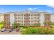 Exterior shot of large condo building with parking, and multiple levels of units with balconies at 4865 Luster Leaf Circle # 402, Myrtle Beach, SC 29577