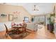 Bright dining area with a chandelier and a glass table next to the living room at 4865 Luster Leaf Circle # 402, Myrtle Beach, SC 29577