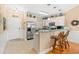 Well-lit kitchen with a breakfast bar, stainless steel appliances, and white cabinetry at 4865 Luster Leaf Circle # 402, Myrtle Beach, SC 29577