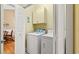 Laundry room with white washer and dryer units and overhead cabinet for storage at 4865 Luster Leaf Circle # 402, Myrtle Beach, SC 29577