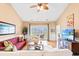Comfortable living room with natural light, ceiling fan, coastal themed decor, and view to screened in porch at 4865 Luster Leaf Circle # 402, Myrtle Beach, SC 29577