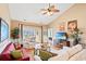 Bright living room with vaulted ceilings, a ceiling fan, cozy furniture, and access to a balcony at 4865 Luster Leaf Circle # 402, Myrtle Beach, SC 29577