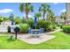 Charming outdoor seating area with table, chairs, grill, and lush landscaping near the pool at 4865 Luster Leaf Circle # 402, Myrtle Beach, SC 29577