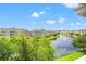 Scenic view of a pond and the surrounding condo buildings under a bright, partly cloudy sky at 4865 Luster Leaf Circle # 402, Myrtle Beach, SC 29577