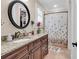 Bathroom featuring a vanity with granite counters, round mirror, and a shower with a tub at 487 Trestle Way, Conway, SC 29526