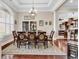 Formal dining room featuring elegant chandelier, rich wood floors, and large window at 487 Trestle Way, Conway, SC 29526