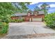 Two-story brick home featuring dormer windows, a two-car garage, and manicured landscaping at 487 Trestle Way, Conway, SC 29526