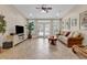 Spacious living room with tile flooring, large windows, ceiling fan, and comfortable sofa with pillows at 487 Trestle Way, Conway, SC 29526