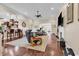 Open-concept living space with hardwood flooring, fireplace, and seamless flow to kitchen at 487 Trestle Way, Conway, SC 29526