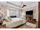 Comfortable main bedroom featuring hardwood floors, trey ceiling, a ceiling fan, sitting area, and a television at 487 Trestle Way, Conway, SC 29526