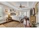 Inviting main bedroom featuring hardwood floors, tray ceiling, and a cozy sitting area with bay windows at 487 Trestle Way, Conway, SC 29526