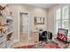 Well-lit office space with a desk, office chair, storage shelves, and view through shuttered window at 487 Trestle Way, Conway, SC 29526