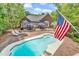 Aerial view of a pool with brick pavers, patio furniture, and a lush green landscape at 487 Trestle Way, Conway, SC 29526