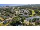 An aerial view of a residential area with a pool, pond, golf course, and lush greenery at 503 20Th Ave. N # 9D, North Myrtle Beach, SC 29582