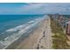 Aerial view of a vibrant beach with many people enjoying the sun and surf at 503 20Th Ave. N # 9D, North Myrtle Beach, SC 29582