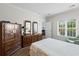 Comfortable bedroom with natural light, wooden dresser, mirrors and ensuite bathroom at 503 20Th Ave. N # 9D, North Myrtle Beach, SC 29582