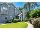 Two-story home with gray siding, a well-manicured lawn, and a sidewalk leading up to the front door at 503 20Th Ave. N # 9D, North Myrtle Beach, SC 29582