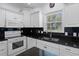 Bright kitchen featuring white cabinets, granite counters, and stainless steel appliances at 503 20Th Ave. N # 9D, North Myrtle Beach, SC 29582