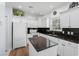 Bright kitchen with white cabinets, black countertops, and stainless steel appliances at 503 20Th Ave. N # 9D, North Myrtle Beach, SC 29582