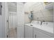 Functional laundry room with washer, dryer, and shelving for organized storage at 503 20Th Ave. N # 9D, North Myrtle Beach, SC 29582