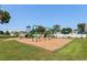 A community playground with swings and a slide on a bright, sunny day at 503 20Th Ave. N # 9D, North Myrtle Beach, SC 29582