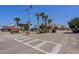 Street view featuring palm trees, a crosswalk, shops, and beach parking at 503 20Th Ave. N # 9D, North Myrtle Beach, SC 29582
