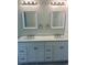 Bathroom vanity with double sinks, quartz countertops, framed mirrors, and updated fixtures at 5310 Pauley Swamp Rd., Conway, SC 29527