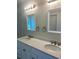 A bathroom vanity with dual sinks, quartz countertops, and framed mirrors at 5310 Pauley Swamp Rd., Conway, SC 29527