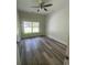 A bright bedroom with beautiful hardwood flooring, ceiling fan, and a view to the outdoors at 5310 Pauley Swamp Rd., Conway, SC 29527