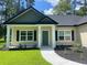 Inviting front porch with a walkway leading up to the front door at 5310 Pauley Swamp Rd., Conway, SC 29527