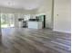 Open-concept kitchen with white cabinets, a center island, and stainless steel appliances at 5310 Pauley Swamp Rd., Conway, SC 29527