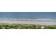 Expansive beach and serene ocean view with lush greenery, palm trees, and inviting beach access at 5523 N Ocean Blvd. # 1410, Myrtle Beach, SC 29577