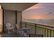Relaxing balcony view showcasing seating with ocean views and a colorful sunset at 5523 N Ocean Blvd. # 1410, Myrtle Beach, SC 29577