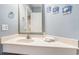 Bathroom featuring a marble countertop, a mirror, and decorative wall art at 5523 N Ocean Blvd. # 1410, Myrtle Beach, SC 29577
