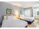 Bedroom showcases two beds, a closet, and a peek into the adjacent bathroom at 5523 N Ocean Blvd. # 1410, Myrtle Beach, SC 29577