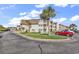 Inviting condo complex with manicured lawn, palm trees, and ample parking spaces at 5601 N Ocean Blvd. # A309, Myrtle Beach, SC 29577