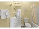 Bright bathroom with a single vanity, commode, decorative butterflies, and a shower at 5801 Oyster Catcher Dr. # 431, North Myrtle Beach, SC 29582
