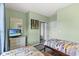 Cozy bedroom featuring twin beds, soft green walls, a television, and mirrored closet doors at 5801 Oyster Catcher Dr. # 431, North Myrtle Beach, SC 29582
