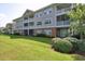 Beautiful condo exterior with private screened in patios, well-manicured lawn, and lush landscaping at 5801 Oyster Catcher Dr. # 431, North Myrtle Beach, SC 29582