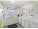 Bright kitchen with white cabinetry, countertops, and tile flooring with views to other spaces at 5801 Oyster Catcher Dr. # 431, North Myrtle Beach, SC 29582