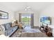 Comfortable living room with a ceiling fan, neutral colors, sliding door access to a balcony at 5801 Oyster Catcher Dr. # 431, North Myrtle Beach, SC 29582