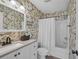 Charming bathroom featuring decorative wallpaper, white vanity, and shower-tub combo at 605 Waterway Village Blvd. # 31A, Myrtle Beach, SC 29579