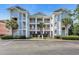 Front view of a condo building, featuring multiple balconies and palm trees at 605 Waterway Village Blvd. # 31A, Myrtle Beach, SC 29579