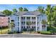 Exterior view of a three-story condo building with white porches and landscaped grounds at 605 Waterway Village Blvd. # 31A, Myrtle Beach, SC 29579