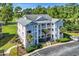 Beautiful condominium with multiple floors and balconies, complemented by lush landscaping and a convenient parking area at 605 Waterway Village Blvd. # 31A, Myrtle Beach, SC 29579