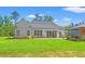 Spacious backyard featuring a patio, well-maintained lawn, and outdoor seating area at 609 Mccown Dr., Conway, SC 29526